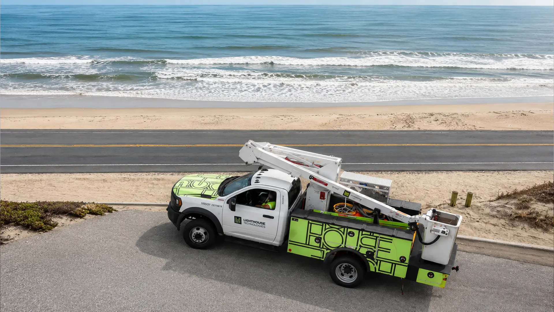 Lighthouse bucket truck on a coastal road